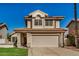 Two-story stucco home with a tile roof, two-car garage and manicured lawn at 6857 S Roosevelt St, Tempe, AZ 85283