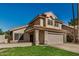 A front view of a home with a tile roof and a two-car garage at 6857 S Roosevelt St, Tempe, AZ 85283