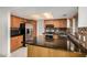 Updated kitchen with granite countertops, stainless steel appliances, and oak cabinets, offering modern functionality at 6857 S Roosevelt St, Tempe, AZ 85283