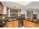 Bright kitchen featuring wooden cabinets, dark countertops and a large window over the sink at 6857 S Roosevelt St, Tempe, AZ 85283
