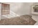 Sunlit living room featuring neutral carpet and tile flooring, offering a spacious and inviting area at 6857 S Roosevelt St, Tempe, AZ 85283
