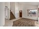 Bright living room with neutral walls, large windows, and staircase access at 6857 S Roosevelt St, Tempe, AZ 85283