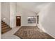 Bright living room with high ceilings, neutral carpet, and a staircase, creating a welcoming atmosphere at 6857 S Roosevelt St, Tempe, AZ 85283
