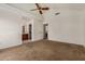 Spacious carpeted main bedroom with vaulted ceilings, a ceiling fan, and a large window at 6857 S Roosevelt St, Tempe, AZ 85283