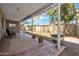 Covered back patio overlooking large backyard, perfect for outdoor dining and entertaining at 7952 W Oregon Ave, Glendale, AZ 85303