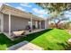Lush backyard featuring green grass, mature tree providing shade, and patio at 7952 W Oregon Ave, Glendale, AZ 85303