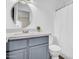 A clean bathroom with a modern vanity, round mirror, and shower with white curtain at 7952 W Oregon Ave, Glendale, AZ 85303