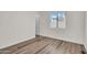 A clean bedroom with wood flooring, a window for natural light, and white walls at 7952 W Oregon Ave, Glendale, AZ 85303