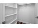 A walk-in closet with built-in white shelving and a clothing rod at 7952 W Oregon Ave, Glendale, AZ 85303