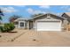Charming single-story home featuring a well-manicured gravel yard and a two-car garage, offering curb appeal and convenience at 7952 W Oregon Ave, Glendale, AZ 85303