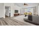 Open-concept living space with wood flooring, a comfortable seating area, and natural light enhancing the home's ambiance at 7952 W Oregon Ave, Glendale, AZ 85303