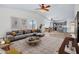 Bright living room features vaulted ceilings, wood floors, and an open floor plan flowing into the modern kitchen at 7952 W Oregon Ave, Glendale, AZ 85303