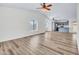 A very large open-concept living area with wood flooring, natural lighting, and ceiling fans at 7952 W Oregon Ave, Glendale, AZ 85303