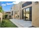 Backyard patio with tiled flooring, landscaped greenery, and access to the home's interior at 7955 E Chaparral Rd # 116, Scottsdale, AZ 85250