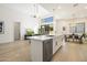 Open-concept kitchen featuring a large island with marble countertops, stainless steel appliances, and modern lighting at 7955 E Chaparral Rd # 116, Scottsdale, AZ 85250