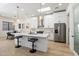 Stylish kitchen with white cabinetry, stainless steel appliances, a center island, and modern pendant lighting at 7955 E Chaparral Rd # 116, Scottsdale, AZ 85250
