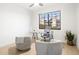 Bright home office with a modern desk, comfortable chairs, and a large window offering natural light at 7955 E Chaparral Rd # 116, Scottsdale, AZ 85250