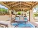Inviting outdoor living space with comfortable seating, a ceiling fan, and a covered patio area near pool at 7955 E Chaparral Rd # 116, Scottsdale, AZ 85250