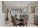Dining room with a glass table, seating for eight, tile floor, and modern decor at 8046 W Agora Ln, Phoenix, AZ 85043
