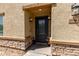 Close-up view of front door with sidelight windows, dark color, and decorative sconces at 8046 W Agora Ln, Phoenix, AZ 85043