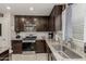 Close-up of kitchen featuring granite counters, stainless steel appliances, and a tiled backsplash at 8046 W Agora Ln, Phoenix, AZ 85043