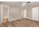 Spacious bedroom with wood floors, neutral walls, and a bathroom en suite at 925 S Longmore -- # 210, Mesa, AZ 85202