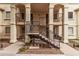 Apartment building exterior with staircases leading to upper floors, and shaded outdoor seating at 925 S Longmore -- # 210, Mesa, AZ 85202