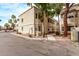 A three-story beige apartment building with desert landscaping under a clear sky at 925 S Longmore -- # 210, Mesa, AZ 85202