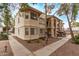 A two-story apartment building with staircases, desert landscaping, and sidewalks at 925 S Longmore -- # 210, Mesa, AZ 85202