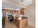 Bright kitchen featuring wood cabinets, black appliances, and a breakfast bar at 925 S Longmore -- # 210, Mesa, AZ 85202