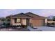 Charming single-story home with stone accents, neutral colors, and a well-manicured front yard at 15154 W Gray Fox Trl, Surprise, AZ 85387