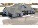 An aerial view shows the gray home with a large gravel lot, a covered porch, and an attached garage at 34949 N Donald Way, San Tan Valley, AZ 85140