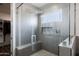 Modern bathroom featuring a glass shower with gray tiling and a built-in shower niche at 34949 N Donald Way, San Tan Valley, AZ 85140