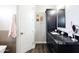 Bathroom boasts a dark vanity with a marble countertop and dark hardwood flooring at 34949 N Donald Way, San Tan Valley, AZ 85140