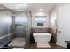Spa-like bathroom featuring a glass shower, a freestanding tub, and neutral tones for a relaxing retreat at 34949 N Donald Way, San Tan Valley, AZ 85140