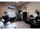 Cozy bedroom setup with a comfortable couch, desk and workout equipment, creating a multifunctional space at 34949 N Donald Way, San Tan Valley, AZ 85140