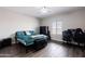 The cozy bedroom features wood floors and a large window at 34949 N Donald Way, San Tan Valley, AZ 85140