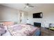 This bedroom includes wood floors and a flat screen television at 34949 N Donald Way, San Tan Valley, AZ 85140
