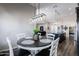 Charming dining area with a round table, white chairs, and an elegant chandelier, perfect for Gathering meals at 34949 N Donald Way, San Tan Valley, AZ 85140