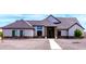Charming single-story home featuring stone accents, gray stucco, well-manicured landscaping, and a welcoming entryway at 34949 N Donald Way, San Tan Valley, AZ 85140