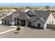 Stylish single-story home with a modern exterior, decorative stone accents and a well-maintained gravel yard at 34949 N Donald Way, San Tan Valley, AZ 85140