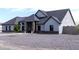 A contemporary home with stone accents, a gravel yard, and modern windows adds curb appeal at 34949 N Donald Way, San Tan Valley, AZ 85140