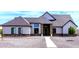 Beautiful single-story home with stone details, manicured trees, and gravel landscaping at 34949 N Donald Way, San Tan Valley, AZ 85140