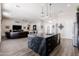 Modern kitchen with a large island and stainless steel appliances is open to the living space at 34949 N Donald Way, San Tan Valley, AZ 85140