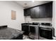 The laundry room features black cabinets and marble countertops at 34949 N Donald Way, San Tan Valley, AZ 85140