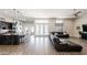 Open-concept living area with wood floors connecting to the kitchen and dining space at 34949 N Donald Way, San Tan Valley, AZ 85140