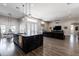 Spacious living area with wood floors flows into the kitchen and dining area at 34949 N Donald Way, San Tan Valley, AZ 85140