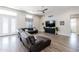 Open living space boasts wood floors, a ceiling fan, and plenty of natural light at 34949 N Donald Way, San Tan Valley, AZ 85140