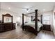 Elegant main bedroom featuring a stunning four-poster bed, a stylish dresser, and a serene atmosphere at 34949 N Donald Way, San Tan Valley, AZ 85140