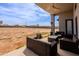 Relaxing covered patio with modern wicker furniture, perfect for enjoying outdoor living and backyard view at 34949 N Donald Way, San Tan Valley, AZ 85140